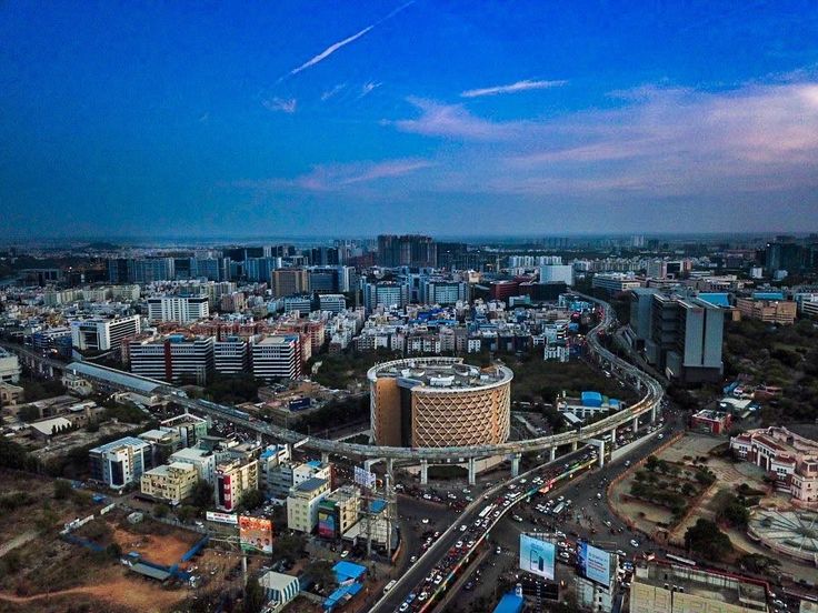 Aerial view of Hyderabad's skyline showcasing modern high-rise buildings, residential communities, and upcoming real estate developments.